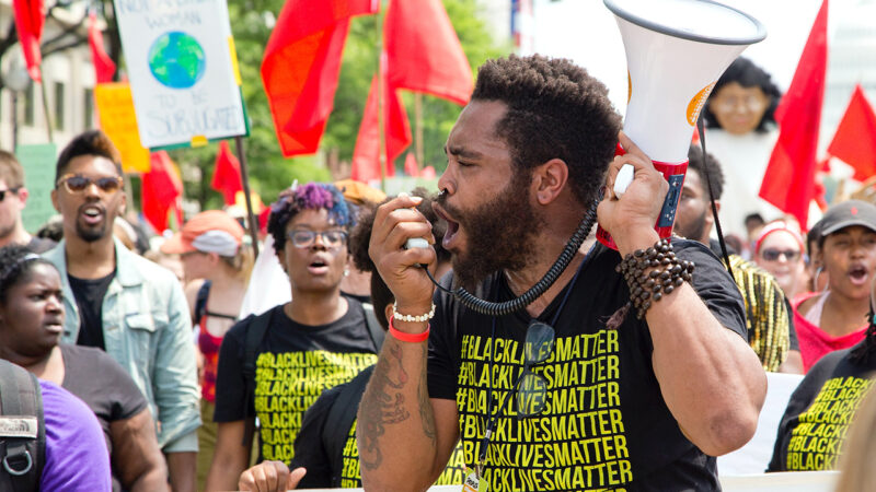 African-American man yelling into a megaphone at a Black Lives Matter march