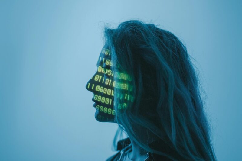 Bu header for article on Pastors delegating tasks to AI, girl with binary numbers (0s and 1s) projected on her face
