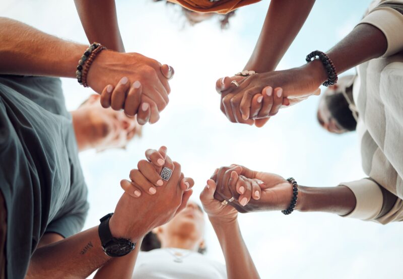 Group holding hands in prayer