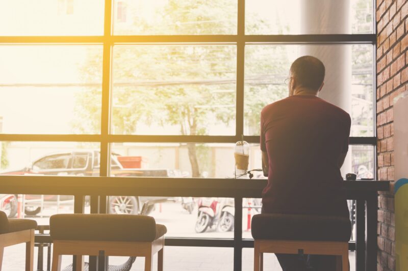man working in coffee shop alone